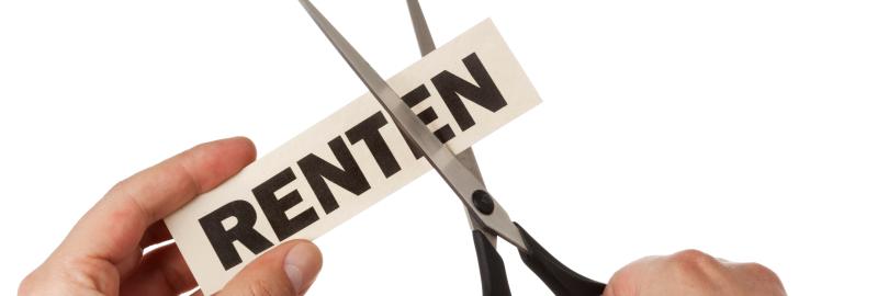 Jemand schneidet mit einer Schere das Ende des Wortes Rente ab