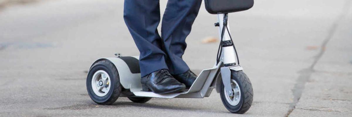 Mann auf einem E-Scooter auf der Straße